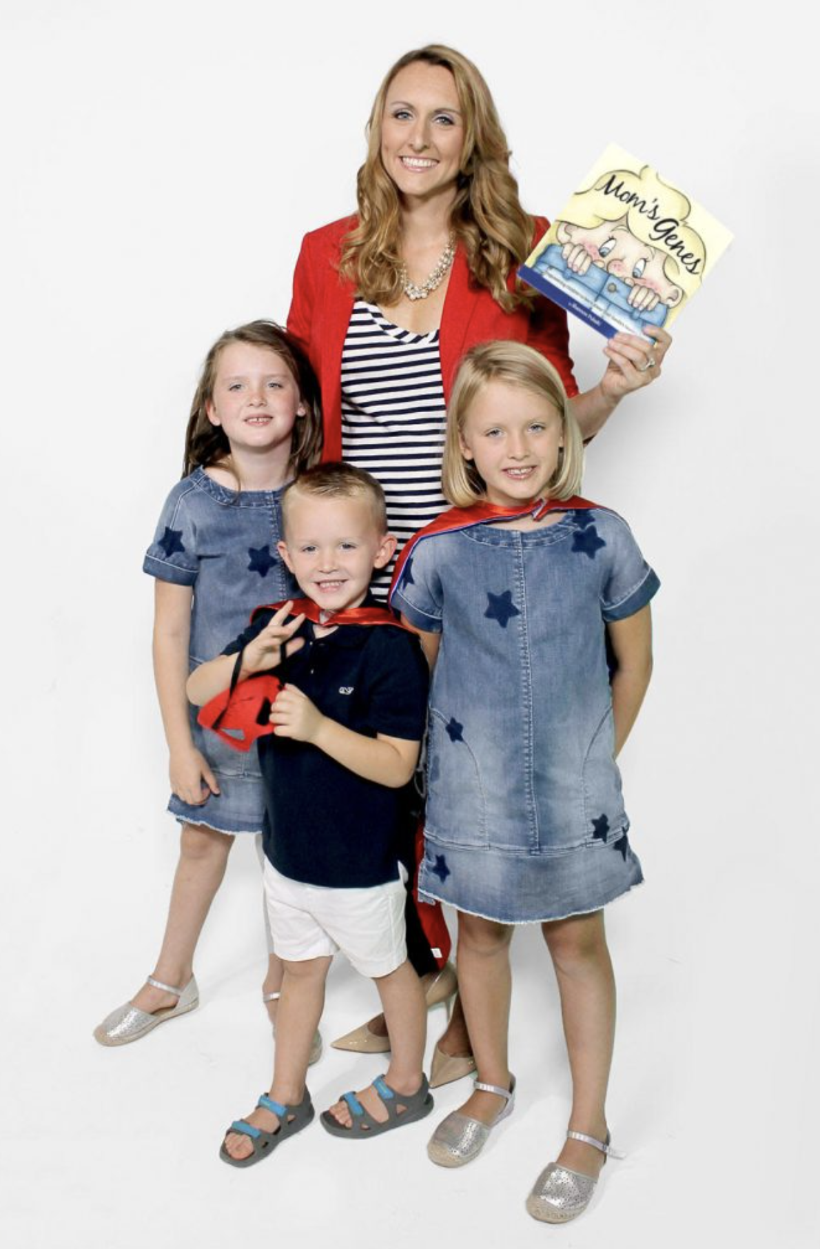 Photo of author Shannon Pulaski holding her book Mom's Genes standing with her three children